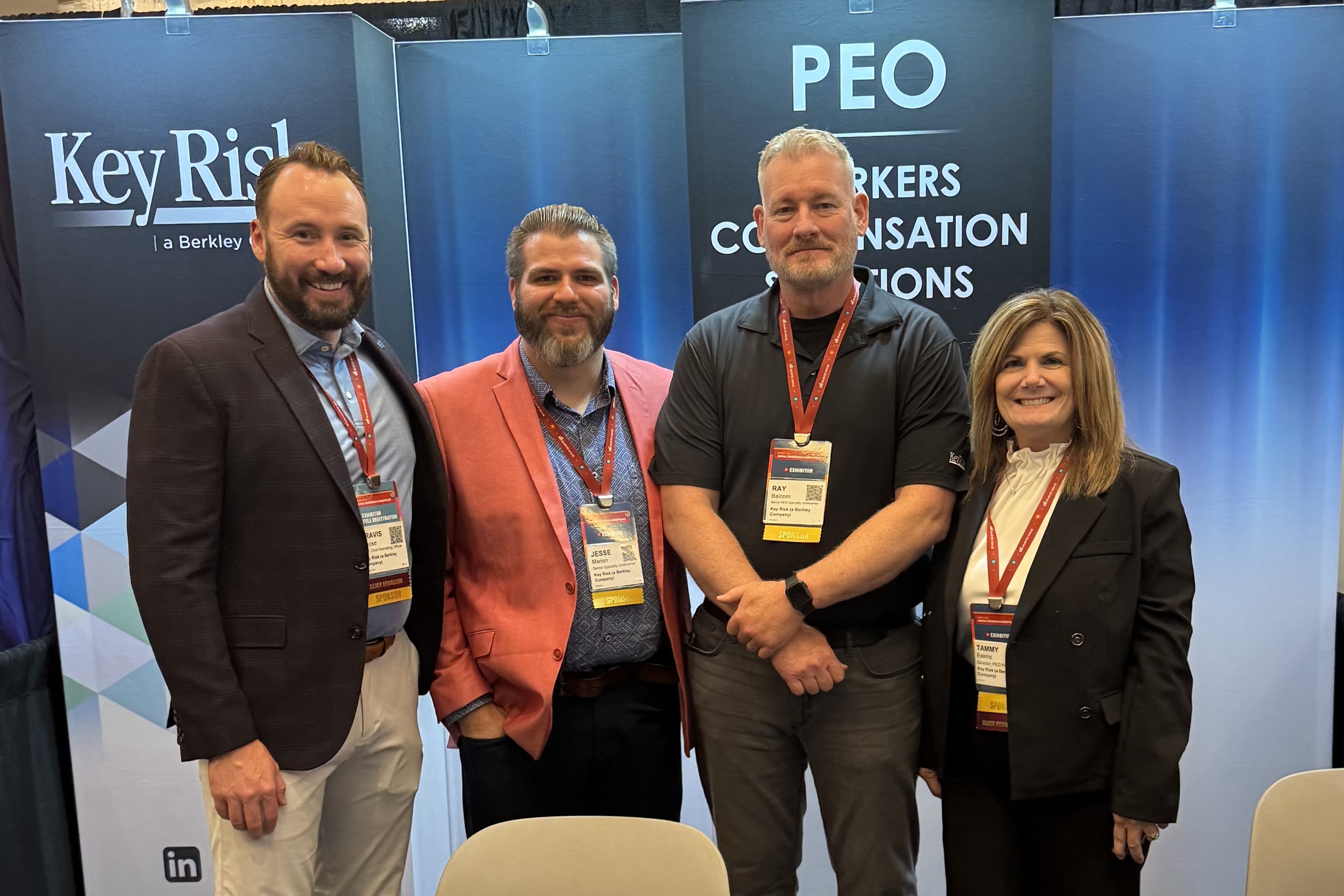 Four team members pose for a photo at the NAPEO conference.